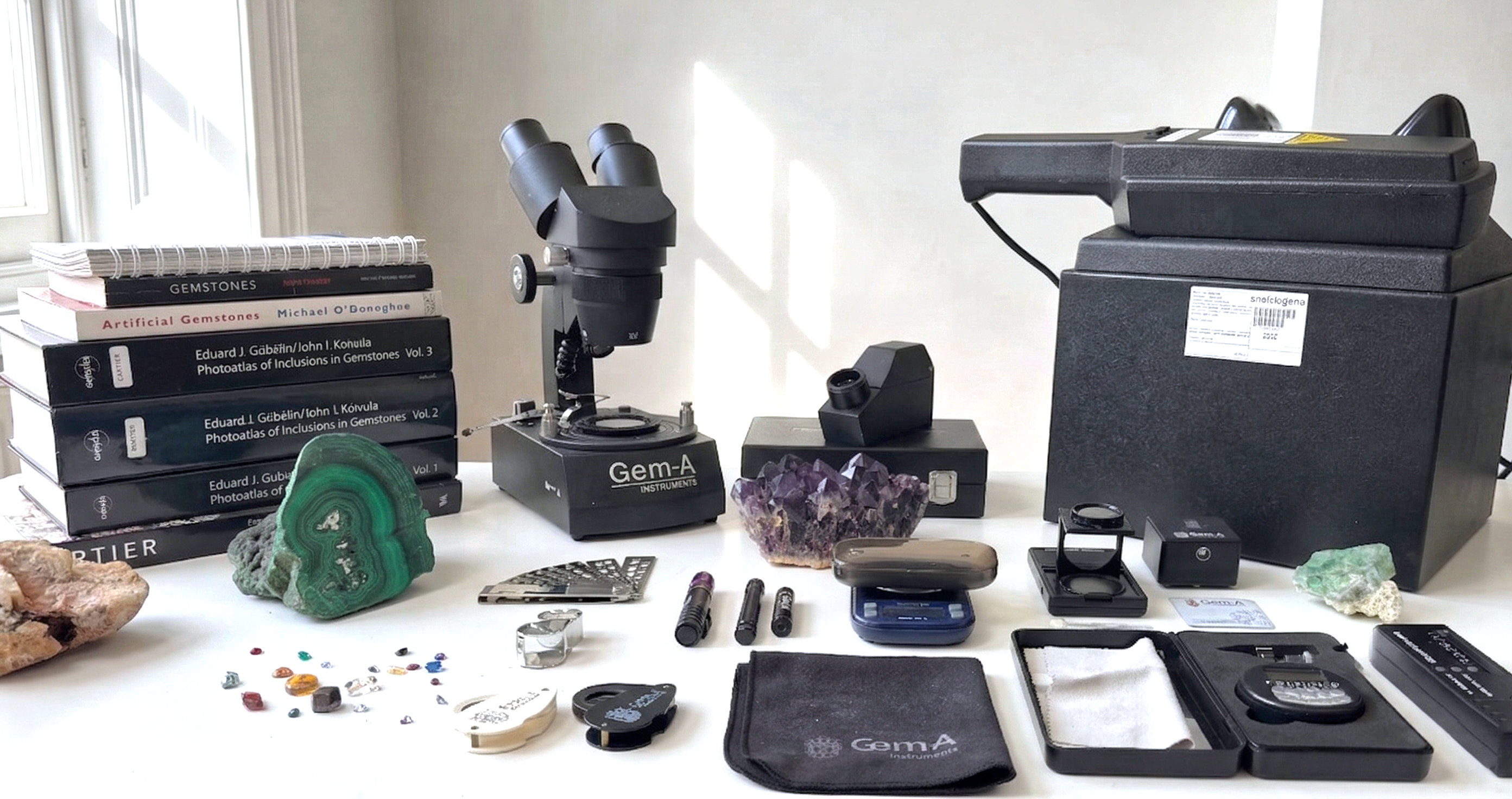 Gem testing equipment on a white desk